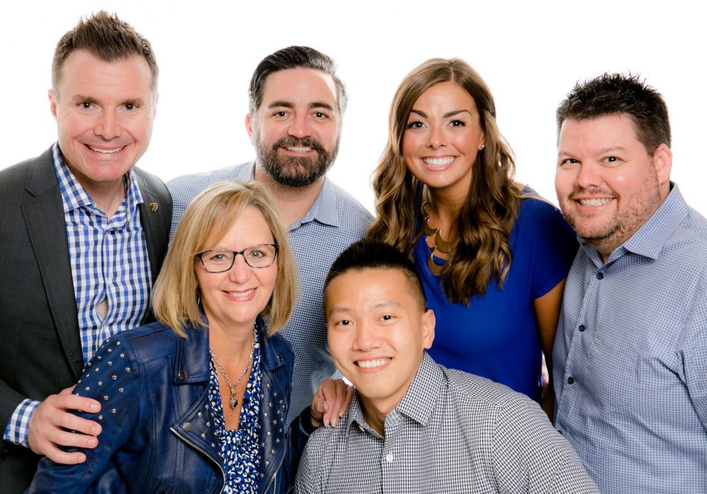 Oakley (left) and his team with PDA's VP of Business & Program Development Patti Sooy (front left), VP of Client Development Chris Moriarity (back, center), Marketing Coach Jenni Bollman (back, center)